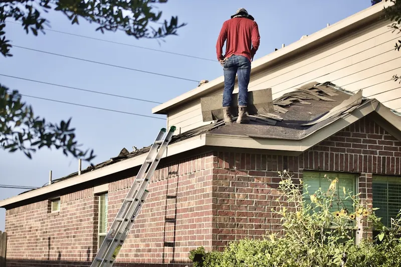 Professional roofer working on a residential roof in Blough